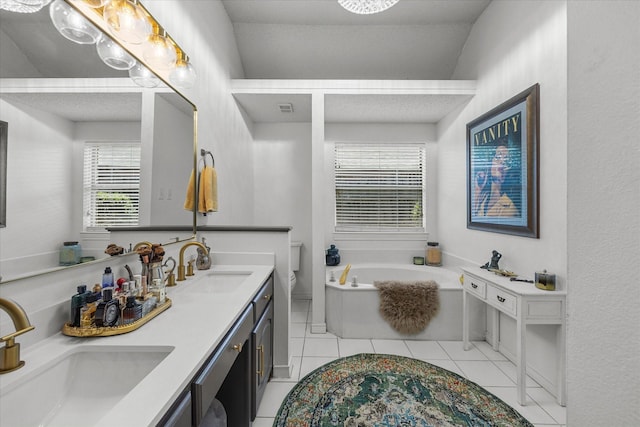 509 Windsor Way, Rockwall, TX 75087 - full bath with a garden tub, double vanity, healthy amount of natural light, and tile patterned flooring
