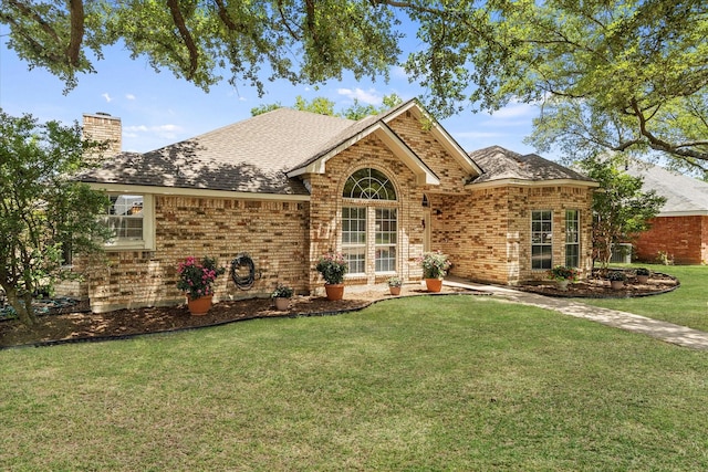 509 Windsor Way, Rockwall, TX 75087 - view of front of home with a chimney, brick siding, a front yard, and roof with shingles