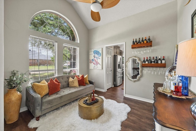 509 Windsor Way, Rockwall, TX 75087 - living area featuring dark wood finished floors, ceiling fan, baseboards, and high vaulted ceiling