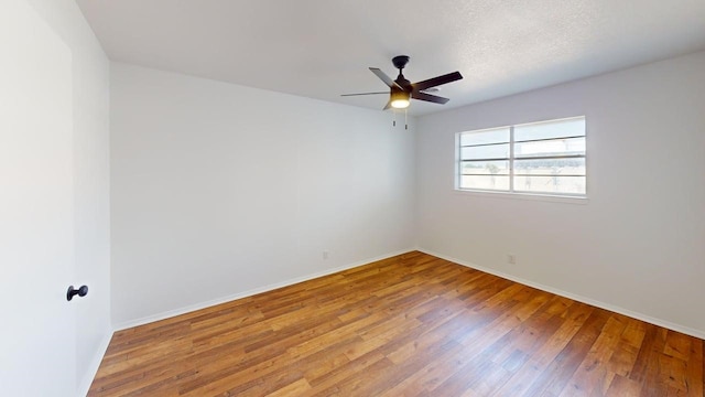 2013 S High St, Brady, TX 76825 - empty room with wood finished floors, ceiling fan, and baseboards