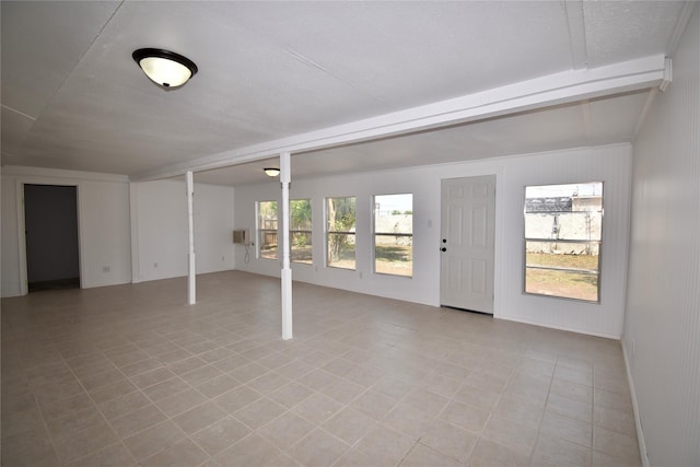 2013 S High St, Brady, TX 76825 - unfurnished living room featuring beamed ceiling