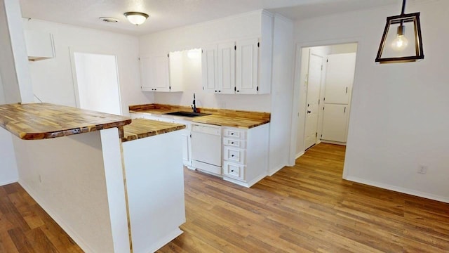 2013 S High St, Brady, TX 76825 - kitchen with butcher block counters, dishwasher, white cabinetry, a sink, and wood finished floors
