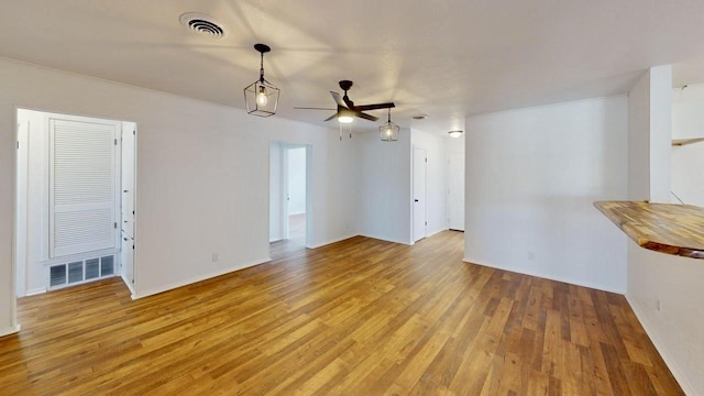 2013 S High St, Brady, TX 76825 - unfurnished living room featuring ceiling fan, light wood-style flooring, and baseboards