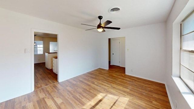 2013 S High St, Brady, TX 76825 - spare room with light wood-style flooring, a ceiling fan, and baseboards