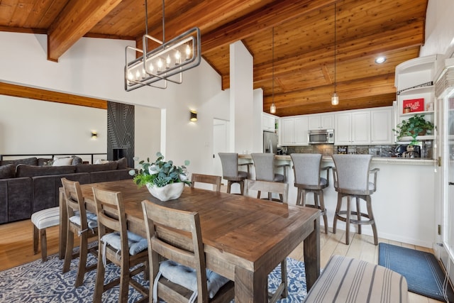 215 N Beverly Dr, Malakoff, TX 75148 - dining area with wood ceiling with exposed beams, light wood-type flooring, a chandelier, and high vaulted ceiling
