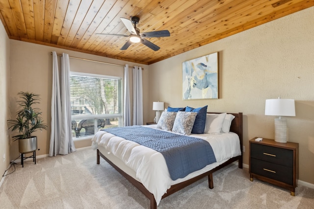 215 N Beverly Dr, Malakoff, TX 75148 - bedroom featuring wood ceiling, light carpet, baseboards, and ceiling fan