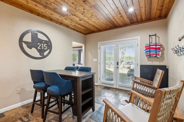 215 N Beverly Dr, Malakoff, TX 75148 - dining space with a textured wall, stone tile flooring, recessed lighting, baseboards, and french doors