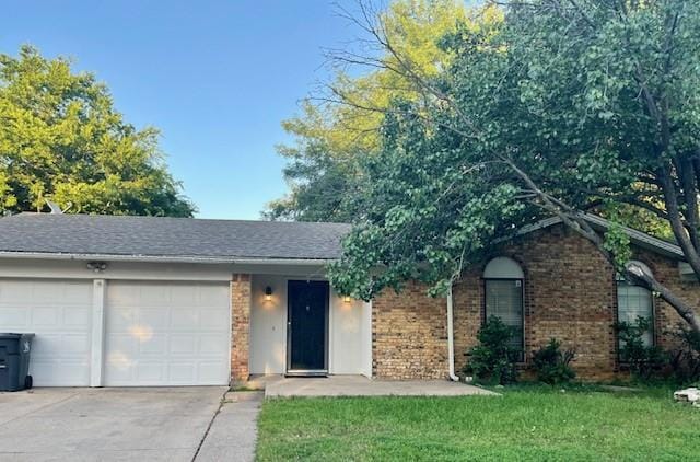 2411 Laredo Ct, Arlington, TX 76015 - ranch-style house featuring driveway, an attached garage, a front lawn, and brick siding