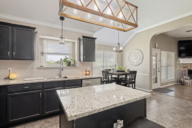 305 Margaret St, Fate, TX 75189 - kitchen featuring lofted ceiling, dark cabinets, arched walkways, healthy amount of natural light, and decorative backsplash