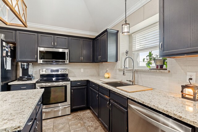 305 Margaret St, Fate, TX 75189 - kitchen with appliances with stainless steel finishes, lofted ceiling, a sink, decorative backsplash, and hanging light fixtures
