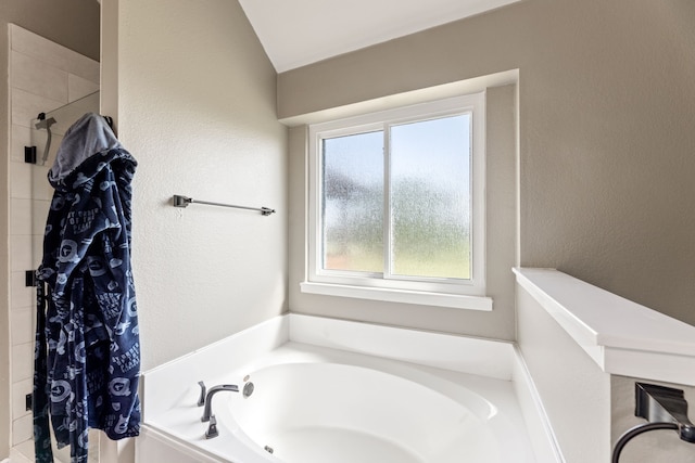305 Margaret St, Fate, TX 75189 - bathroom featuring a garden tub, tiled shower, and a textured wall
