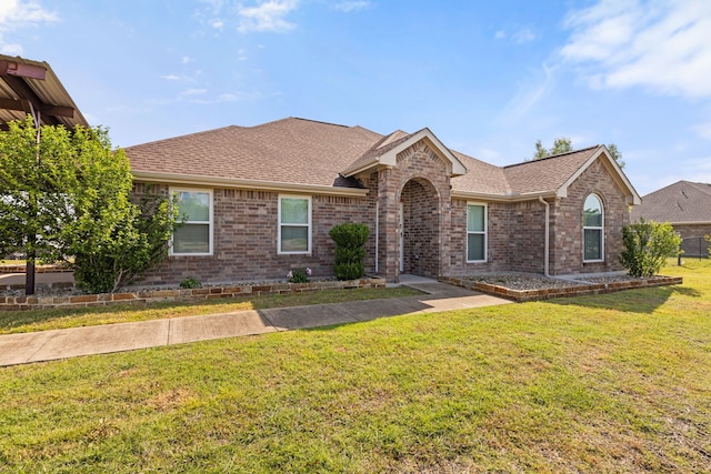305 Margaret St, Fate, TX 75189 - ranch-style home featuring brick siding, a front yard, and a shingled roof