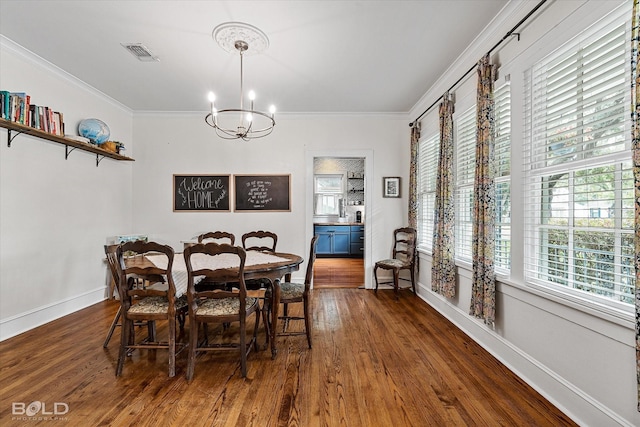 3526 Greenway Pl, Shreveport, LA 71105 - dining space with a chandelier, healthy amount of natural light, wood finished floors, ornamental molding, and baseboards