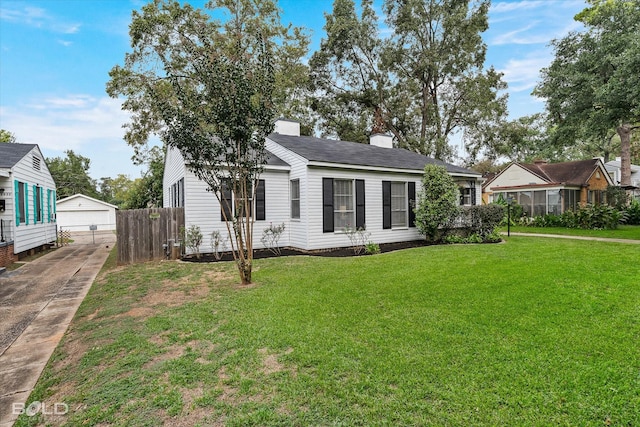 3526 Greenway Pl, Shreveport, LA 71105 - view of front facade with an outbuilding, a detached garage, and roof with shingles