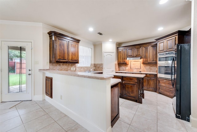 2917 Cascade Dr, Plano, TX 75025 - kitchen featuring light countertops, freestanding refrigerator, crown molding, light tile patterned floors, and backsplash