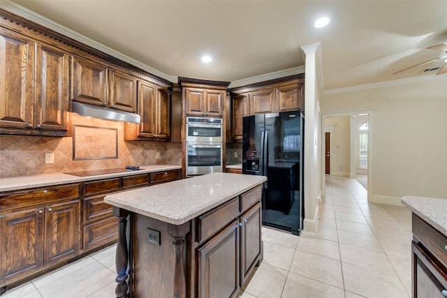 2917 Cascade Dr, Plano, TX 75025 - kitchen with black appliances, under cabinet range hood, light tile patterned floors, backsplash, and ornamental molding