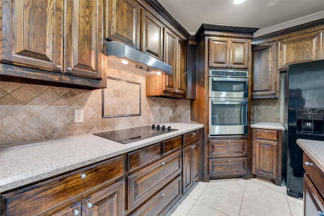 2917 Cascade Dr, Plano, TX 75025 - kitchen with black appliances, under cabinet range hood, tasteful backsplash, light tile patterned floors, and ornamental molding
