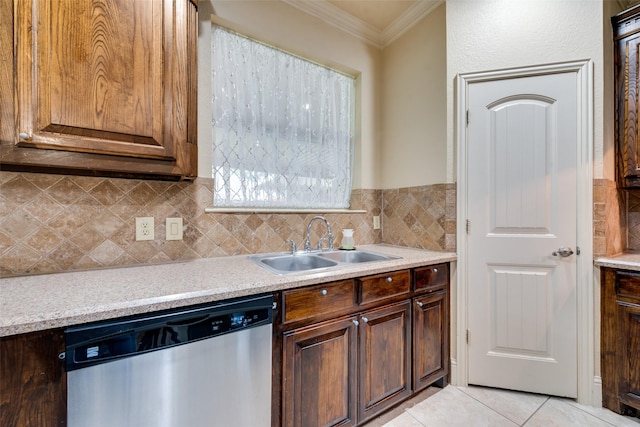 2917 Cascade Dr, Plano, TX 75025 - kitchen with stainless steel dishwasher, a sink, crown molding, light countertops, and light tile patterned flooring