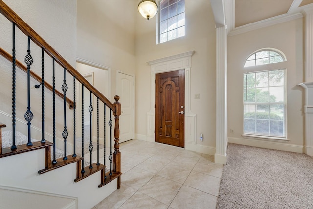 2917 Cascade Dr, Plano, TX 75025 - foyer featuring a high ceiling, stairway, crown molding, light tile patterned floors, and baseboards