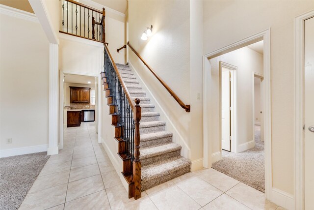 2917 Cascade Dr, Plano, TX 75025 - stairs featuring carpet flooring, a high ceiling, tile patterned flooring, and baseboards
