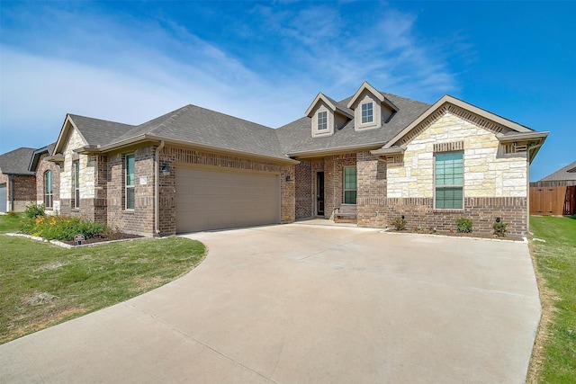 128 Colonial Dr, Joshua, TX 76058 - french country style house with roof with shingles, an attached garage, concrete driveway, and brick siding