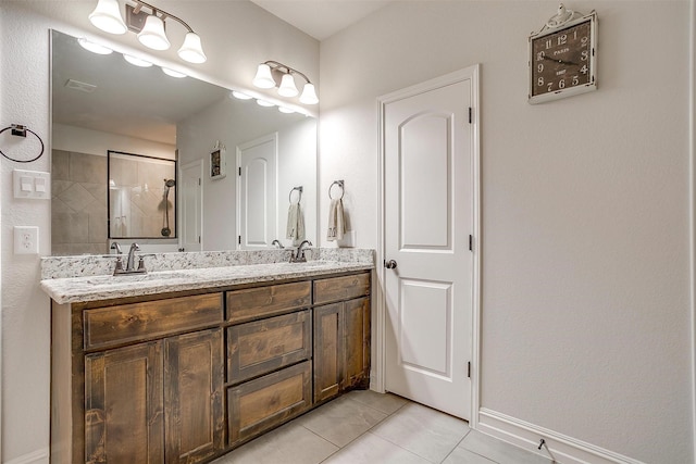 128 Colonial Dr, Joshua, TX 76058 - full bathroom with double vanity, tile patterned flooring, tiled shower, and baseboards