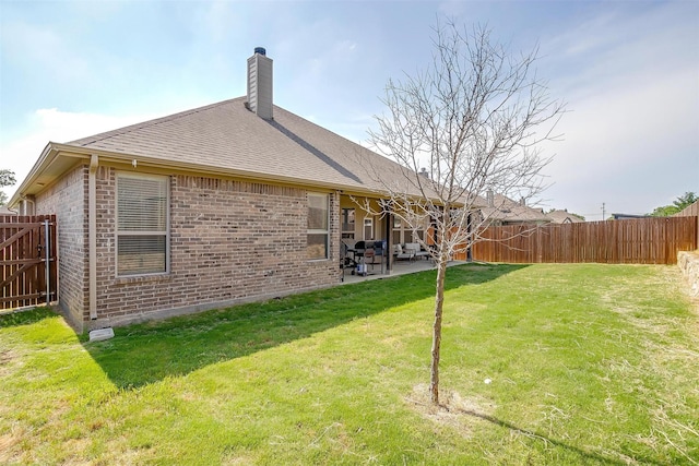 128 Colonial Dr, Joshua, TX 76058 - back of property featuring brick siding, a patio area, a chimney, and roof with shingles