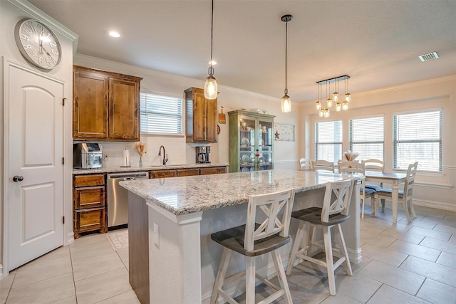 128 Colonial Dr, Joshua, TX 76058 - kitchen featuring stainless steel dishwasher, brown cabinetry, light tile patterned flooring, a center island, and ornamental molding