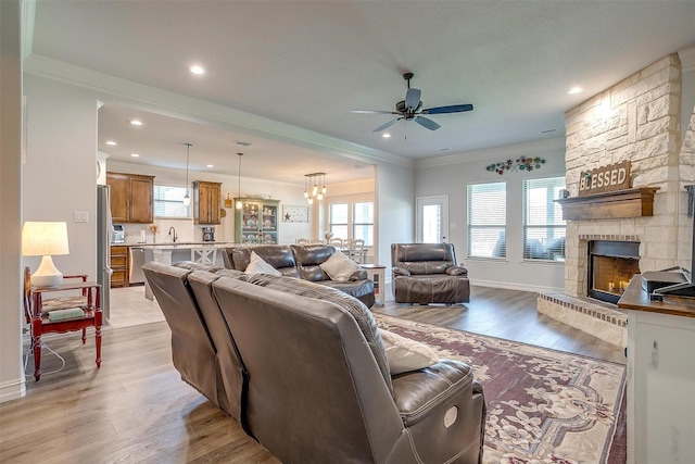 128 Colonial Dr, Joshua, TX 76058 - living area with a ceiling fan, ornamental molding, a fireplace, light wood-style flooring, and recessed lighting
