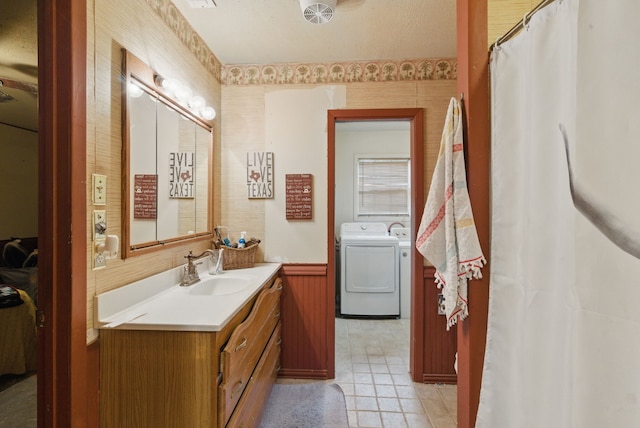 210 Aikens St, Lipan, TX 76462 - bathroom with washing machine and dryer, vanity, and wainscoting