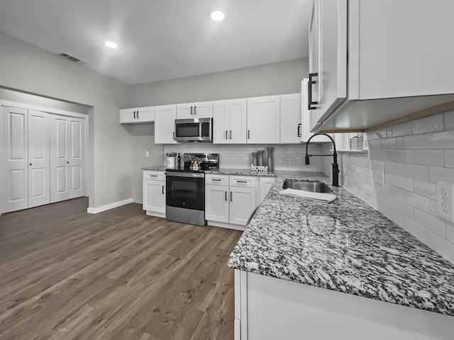 102 Bois D Arc St, Whitesboro, TX 76273 - kitchen featuring appliances with stainless steel finishes, a sink, stone counters, white cabinets, and decorative backsplash