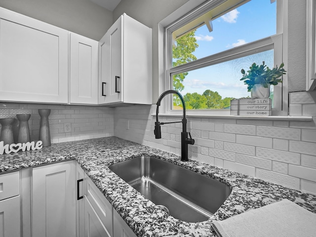 102 Bois D Arc St, Whitesboro, TX 76273 - kitchen featuring a sink, decorative backsplash, stone counters, and white cabinets