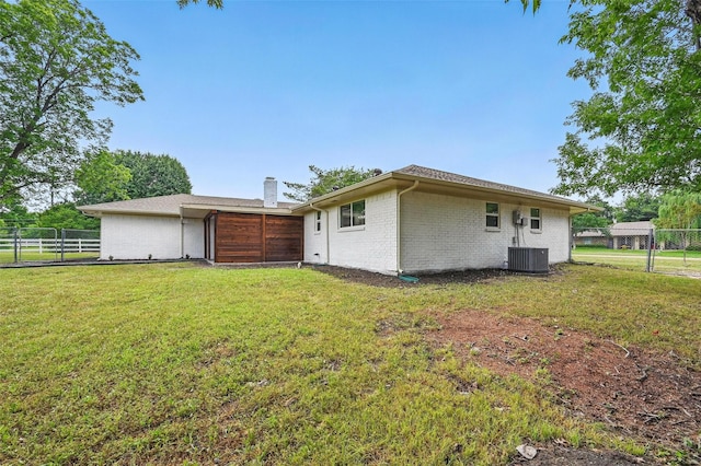 342 Willow Wood St, Murphy, TX 75094 - back of property featuring brick siding, a chimney, central air condition unit, and an attached garage