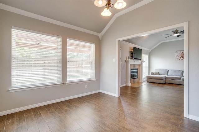 2900 Miles Way, Bedford, TX 76021 - living area featuring lofted ceiling, ornamental molding, a fireplace, wood finished floors, and a chandelier
