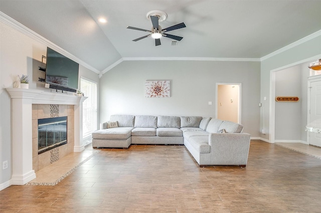 2900 Miles Way, Bedford, TX 76021 - living room with ceiling fan, ornamental molding, a tiled fireplace, baseboards, and vaulted ceiling