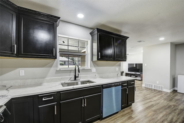 12111 Galva Dr, Dallas, TX 75243 - kitchen with stainless steel dishwasher, dark cabinets, a sink, a textured ceiling, and recessed lighting