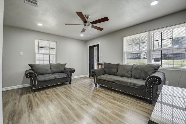 12111 Galva Dr, Dallas, TX 75243 - living area featuring a ceiling fan, light wood-style flooring, recessed lighting, baseboards, and a textured ceiling