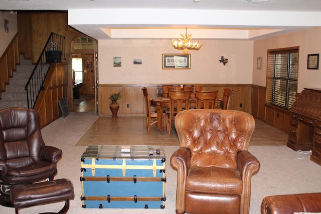 801 County Road 313, Eastland, TX 76448 - carpeted living area featuring wooden walls, a wainscoted wall, stairway, a chandelier, and tile patterned floors