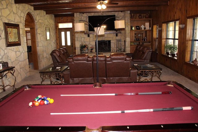 801 County Road 313, Eastland, TX 76448 - playroom with billiards table, a stone fireplace, healthy amount of natural light, wooden walls, and wood ceiling with exposed beams
