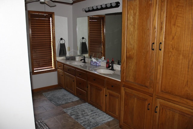 801 County Road 313, Eastland, TX 76448 - full bathroom with a ceiling fan, double vanity, and baseboards