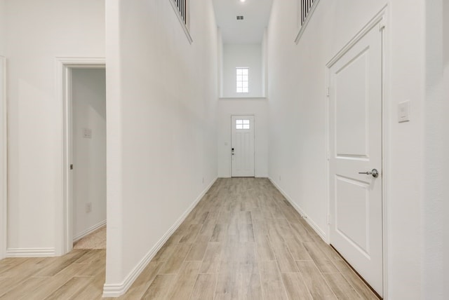 801 Enys Way, Mckinney, TX 75069 - hall with light wood finished floors, baseboards, and a towering ceiling
