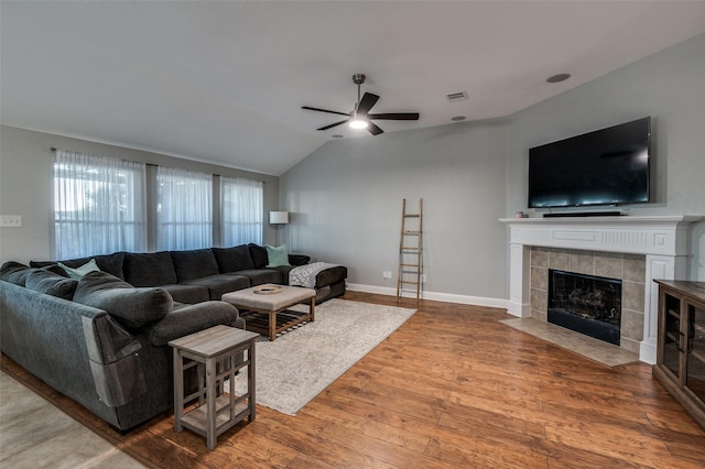 1350 Amistad Dr, Prosper, TX 75078 - living area with a ceiling fan, wood finished floors, lofted ceiling, a tile fireplace, and baseboards