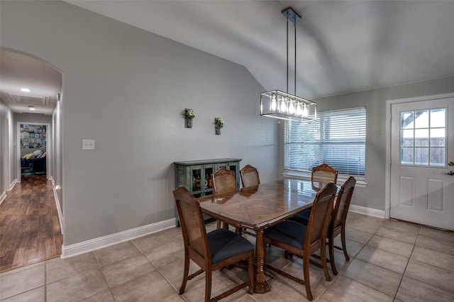 1350 Amistad Dr, Prosper, TX 75078 - dining space featuring vaulted ceiling, baseboards, arched walkways, and light tile patterned floors