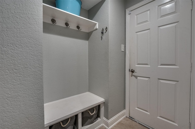 1350 Amistad Dr, Prosper, TX 75078 - mudroom featuring a textured wall, light tile patterned flooring, and baseboards