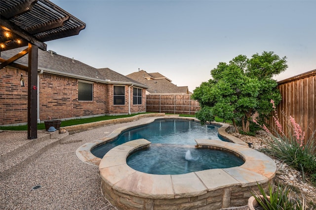 1350 Amistad Dr, Prosper, TX 75078 - pool at dusk featuring a fenced backyard and a pool with connected hot tub