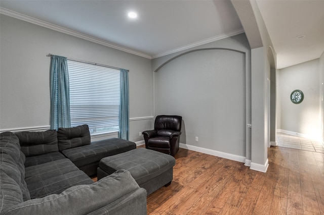 1350 Amistad Dr, Prosper, TX 75078 - living room with wood finished floors, baseboards, crown molding, and arched walkways