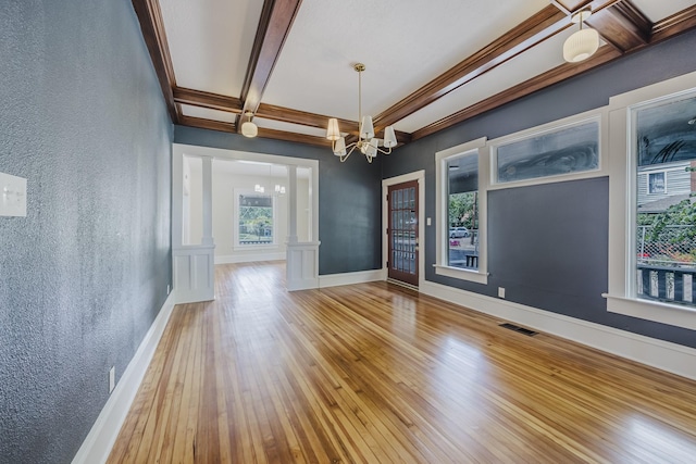 5532 Reiger Ave, Dallas, TX 75214 - unfurnished room with a textured wall, a chandelier, beamed ceiling, wood-type flooring, and baseboards