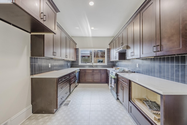 5532 Reiger Ave, Dallas, TX 75214 - kitchen with stainless steel appliances, decorative backsplash, under cabinet range hood, light countertops, and recessed lighting