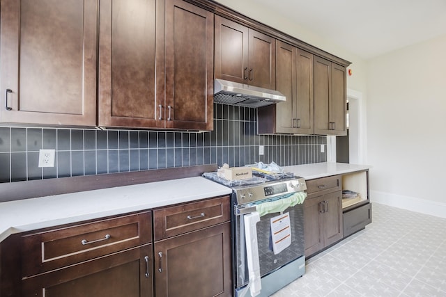 5532 Reiger Ave, Dallas, TX 75214 - kitchen featuring stainless steel electric range oven, under cabinet range hood, baseboards, dark brown cabinetry, and tasteful backsplash