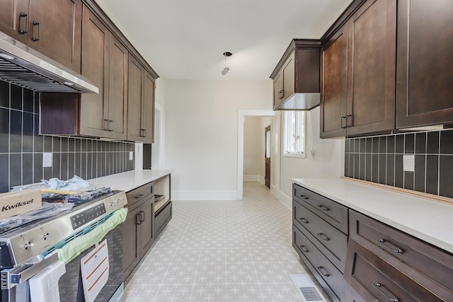 5532 Reiger Ave, Dallas, TX 75214 - kitchen with gas stove, under cabinet range hood, light floors, and tasteful backsplash